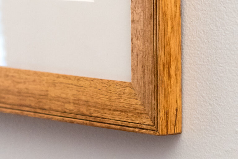Detail of hand carved picture frame from reclaimed timber.