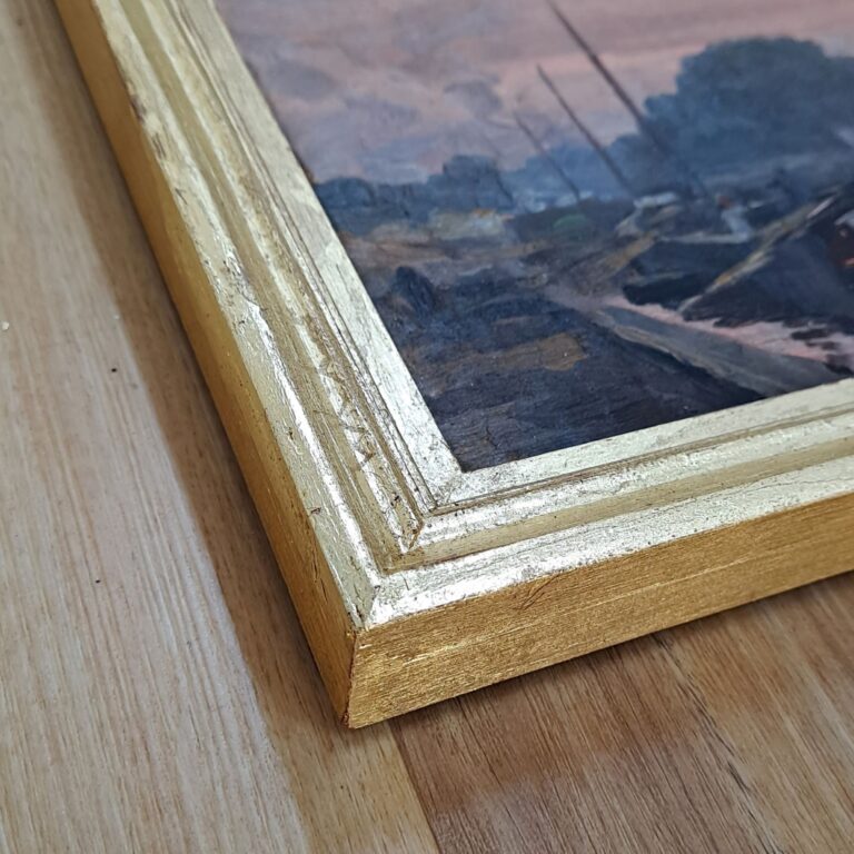 Detail of hand-carved frame finished with gold leaf.
